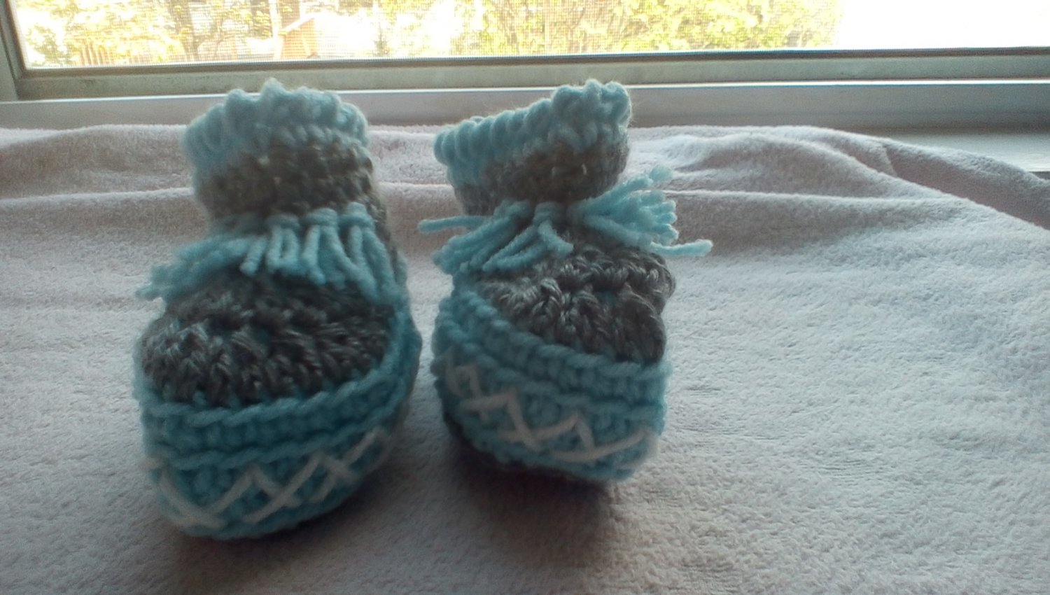 Newborn two toned light blue, and gray moccasins