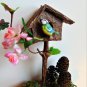Birdhouse with titmouse bird.