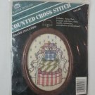 Cross stitch Pile of Presents with wood frame and hanging screw 4 x 6 oval