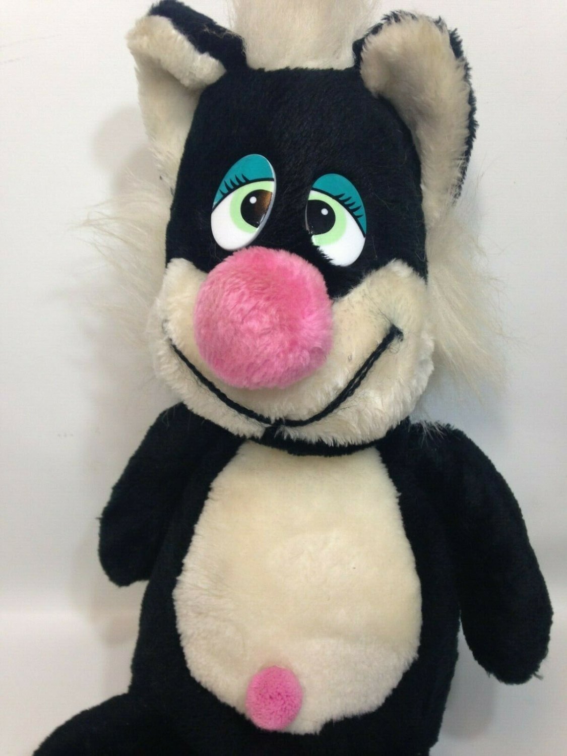 plush black cat with green eyes