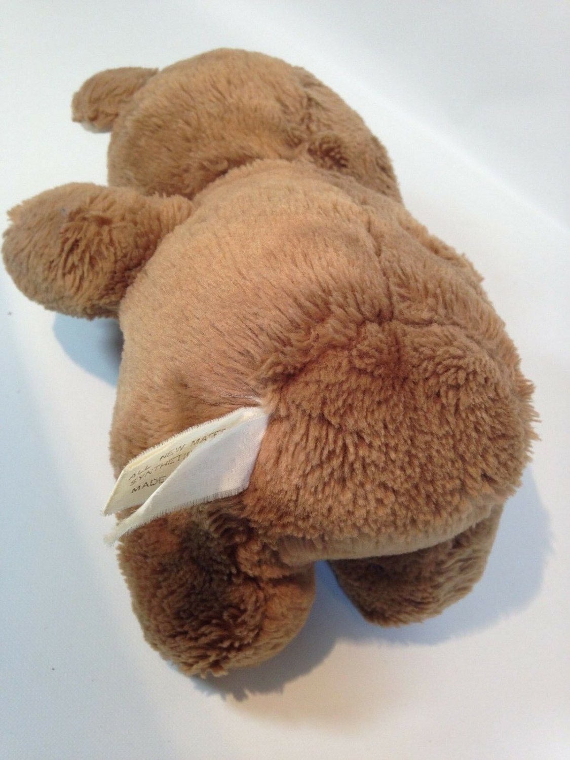 brown stuffed animal with teeth