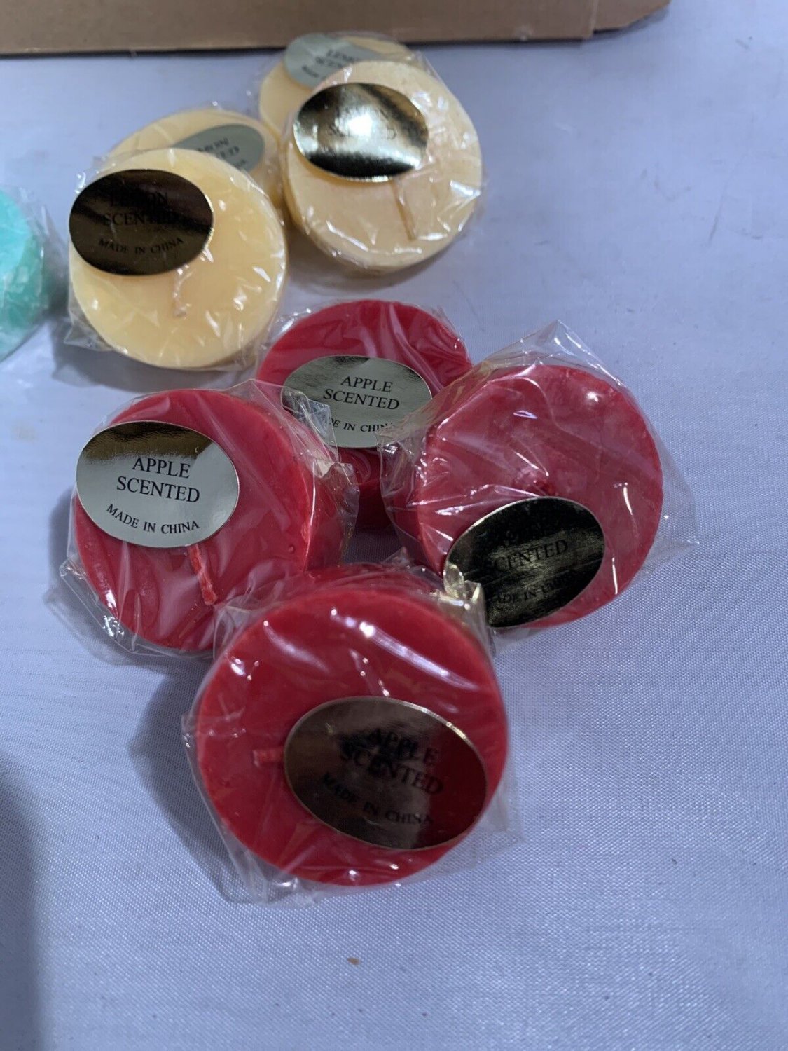 One dozen small Variety Scented Candles, Ocean breeze, Apple,Lemon. Four of each