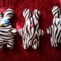 Cute handmade and uniquely designed stuffy bunny: zebra pattern, blue eyes and green nose