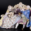 Decor Art. Germany. Meissen Sculpture. A Couple playing music on a sofa.