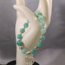 Aquamarine Gemstone Bracelet Has a silver tone Tree of Life heart charm.