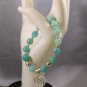 Aquamarine Gemstone Bracelet Has a silver tone Tree of Life heart charm.