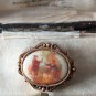 VINTAGE Small Goldtone Framed Glass Printed Fragonard Courting Couple BROOCH.