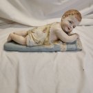 Vintage German Bisque Porcelain Piano Baby Figurine Lying On Blue Pillow