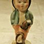 Hummel-Like Boy Figurine Depicting Boy Coming from Market with Umbrella & Basket