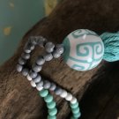 Natural wood bead and tassel necklace with porcelain bead