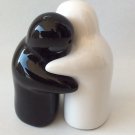 Salt n pepper ceramic shakers kissing couple .