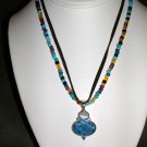 Beaded and leather necklace with blue and white pendant