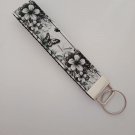 Black and white flower and butterfly print key fob wristlet Black and white flower and butterfly print key fob wristlet