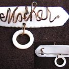 Mother of pearl pin spells MOTHER in gold tone wire Mother of pearl pin spells MOTHER in gold tone wire