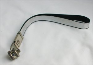 Heavy black and silver plastic camera strap metal fittings