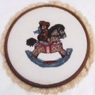 Finished completed cross stitch bear on rocking horse 10 inch round