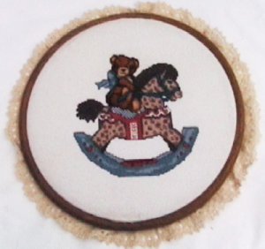 Finished completed cross stitch bear on rocking horse 10 inch round