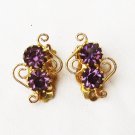 Clip earrings purple rhinestones in gold tone filigree scroll accents Clip earrings purple rhinestones in gold tone filigree scroll accents