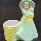 Shawnee Victorian lady girl green dress & bonnet at yellow well planter vase