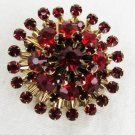 Red pronged rhinestone starburst pin vintage brooch gold tone back excellent shape
