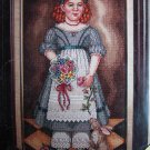 Sunday Best cross stitch design girl in blue with rabbit and flowers