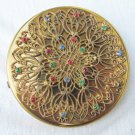 Jeweled gold tone filigree flower motif compact unmarked 3" diameter