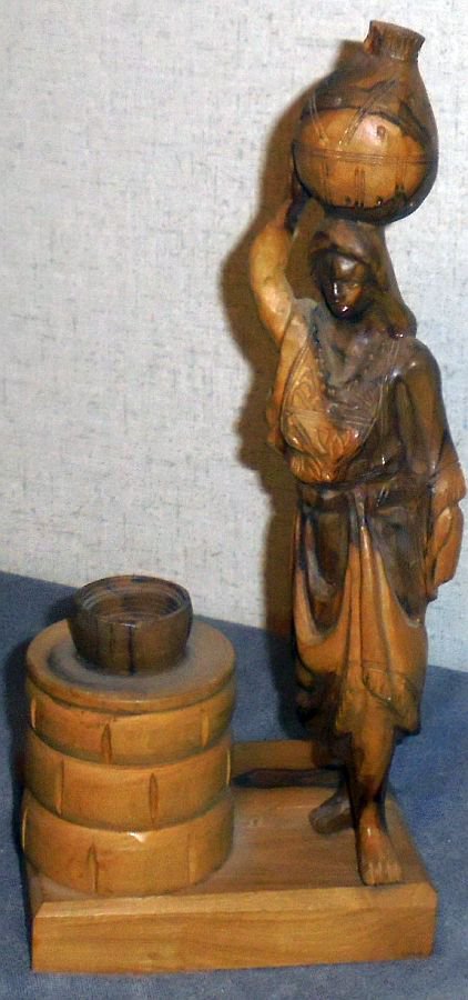 Hand carved water woman by well wood