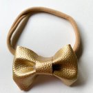 Golden stretchable hair bow.