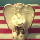 "Knelling Angel holding a Dove"