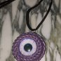 Purple Cyclops necklace  [0007]