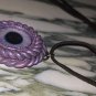 Purple Cyclops necklace  [0007]
