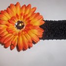 Orange 4 inch Gerbera Daisy hair clip on a black 1.5 inch crochet headband
