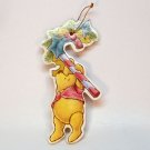 Vintage Winnie the Pooh cardboard Christmas ornament holding candy cane