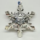 Silver plate 2002 snowflake Christmas ornament with an M logo or initial