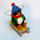 penguin on a sled Christmas ornament penguin on a sled Christmas ornament