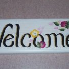 welcome sign with burgundy & small yellow flowers