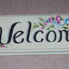 welcome wilth painted blue ribbon & small pink flowers