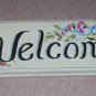 welcome wilth painted blue ribbon & small pink flowers