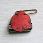 tiny blue celluloid doll pin with rhinestones in a leather pocket