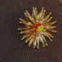 ball tipped spiny starburst brooch with amber glass center - vintage jewelry