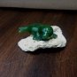 Carved jade Alaska sea lion on pumice stone