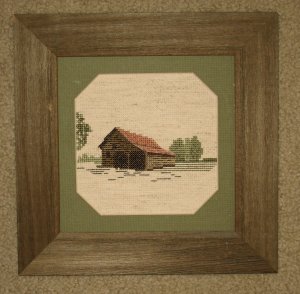 Framed stitched piece in barnboard frame