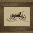 Framed cross stitched piece in barnboard frame