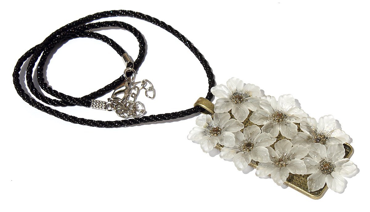 Bronze pendant necklace with a set of seven small white flowers on a black cord: "flowers"