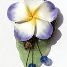 Bronze brooch including a large flower on a lucite leaf all adorned with four glass beads: "Exotic"