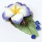 Bronze brooch including a large flower on a lucite leaf all adorned with four glass beads: "Exotic"