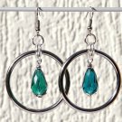 Large silver hoop earrings with a green faceted glass drop in the center: "Verdaya"