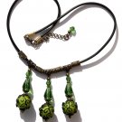 Necklace with three embossed green glass beads and three glass drops on a rubber cord: "Mystery"