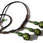 Necklace with three embossed green glass beads and three glass drops on a rubber cord: "Mystery"