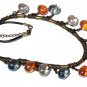Bronze necklace with twelve crystal nugget beads of three different colors on a rubber cord: "Maya"
